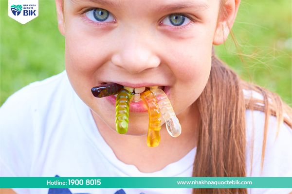 Why do children get tooth decay when eating candy?